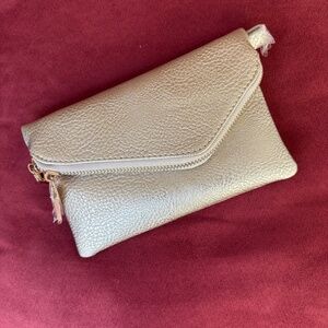 Gold tone convertible wristlet/shoulder bag. NWT